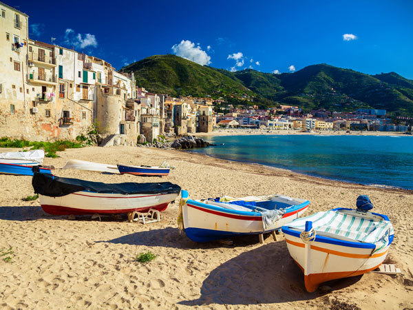 boats docked on the seaside village of Cefalù, Sicily