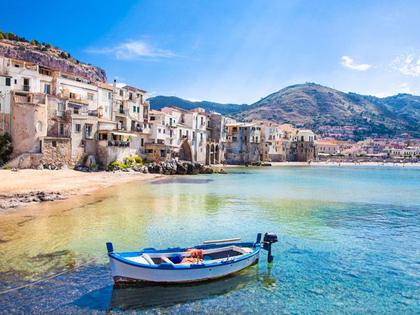 beautiful old harbour with wooden fishing boat in Cefalu, Sicily, Italy.