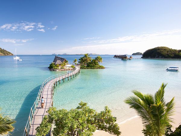 a boardwalk across the crystal clear waters surrounding Likuliku Lagoon Resort