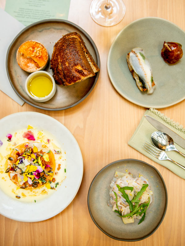 a variety of dishes displayed on the table at Prado, Lisbon