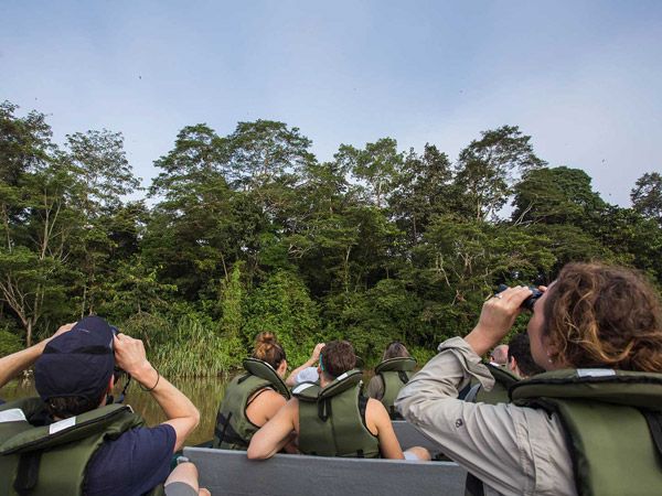 tourists doing some bird watching on a river cruise