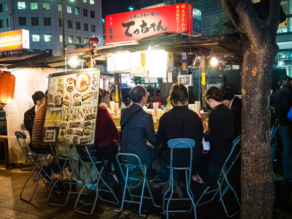 diners sitting side by side at a Yatai food stall in Fukuoka