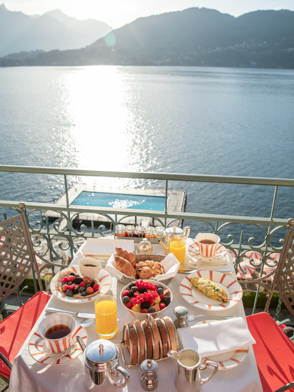 a breakfast setup overlooking Lake Como at lake views at Grand Hotel Tremezzo