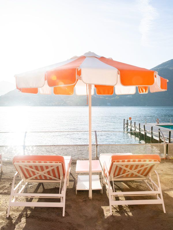 striped sun loungers facing Lake Como