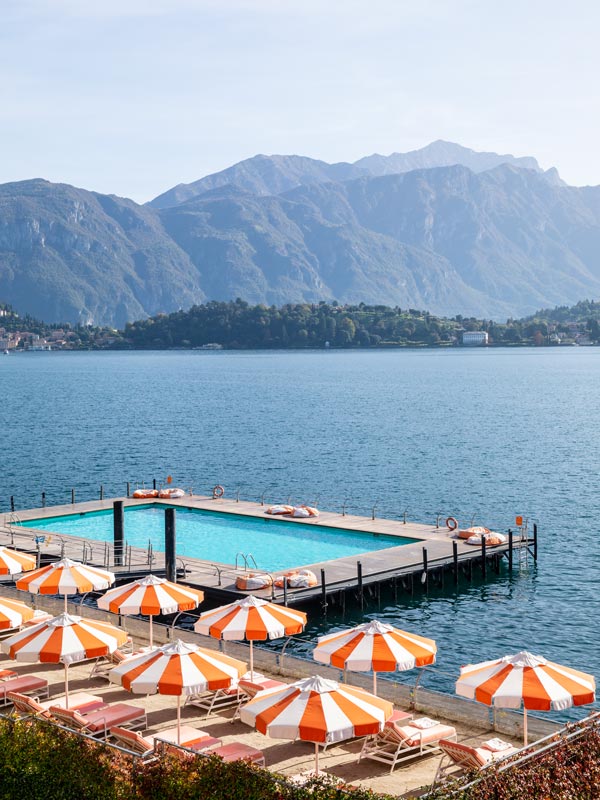 a floating pool with orange umbrellas at Grand Hotel Tremezzo