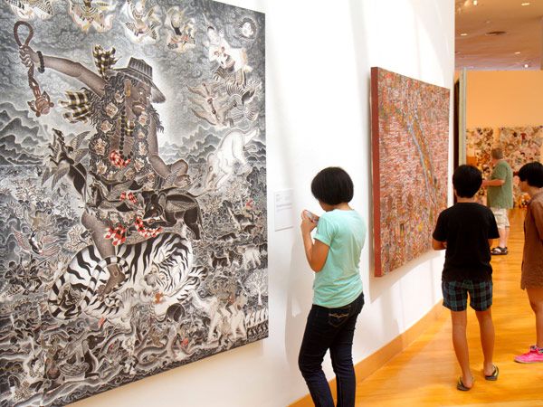 people looking at the art displays inside Bangkok Art and Culture Centre