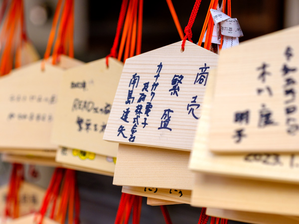 small wooden plaques with written wishes hanging up at the shrine in Fukuoka