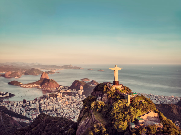 an aerial view of the towering statue of Christ the Redeemer in Brazil