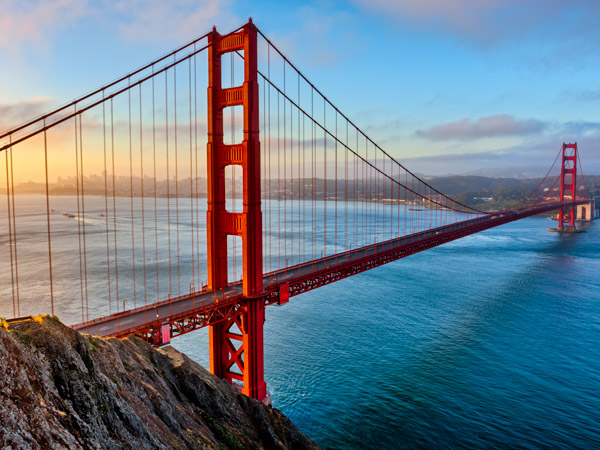 an aerial view of the golden gate bridge at sunset