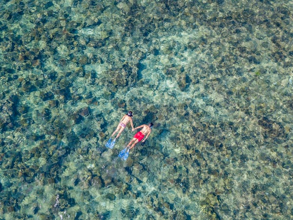 a couple snorkelling around Mociu Island
