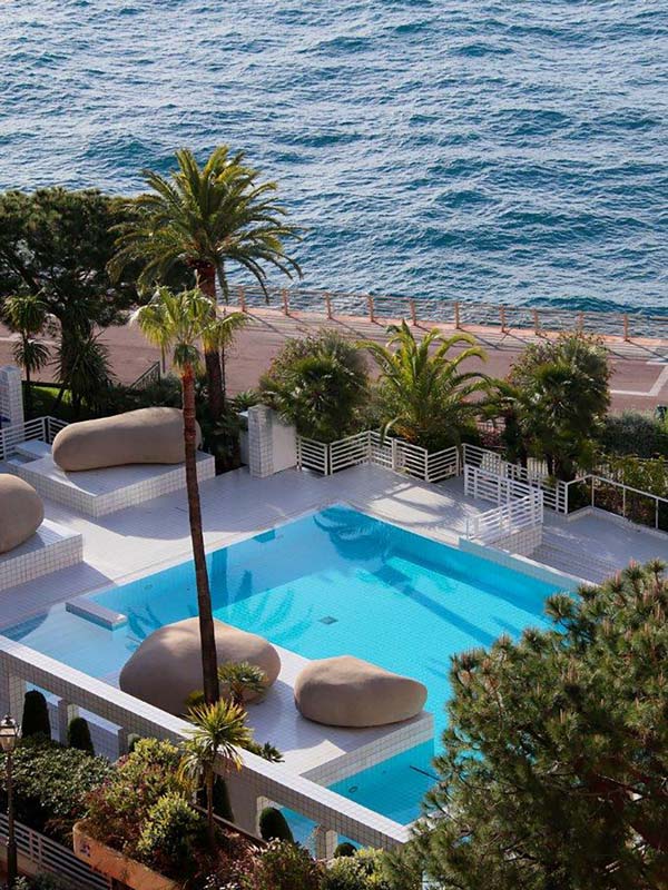 an outdoor pool next to the sea in Columbus Monte-Carlo, Monaco
