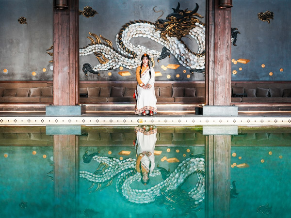 a woman sitting on the side of the pool at St Regis Lhasa