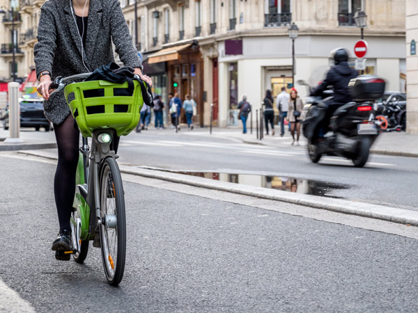woman riding Velib bike in paris
