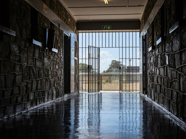 behind bars at the prison cell on Robben Island