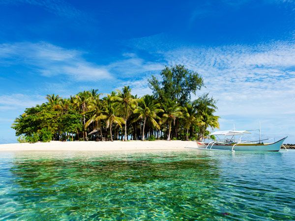 a small palm-fringed Guyam Island in Siargao, Philippines