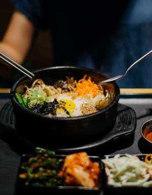 Woman eating bibimbap in Korean restaurant