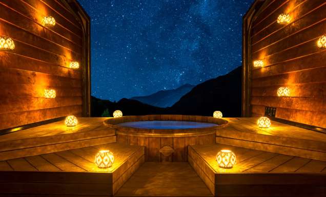 bright lamps surrounding Onsen Hot Pools at night