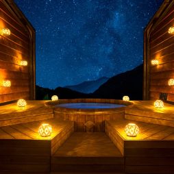 bright lamps surrounding Onsen Hot Pools at night
