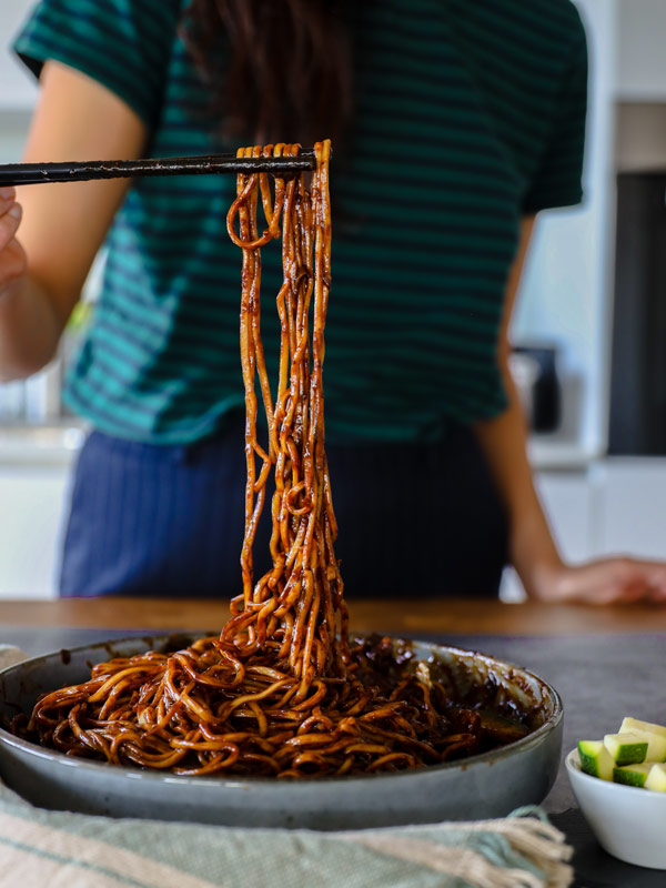 a woman eating Jajangmyeon