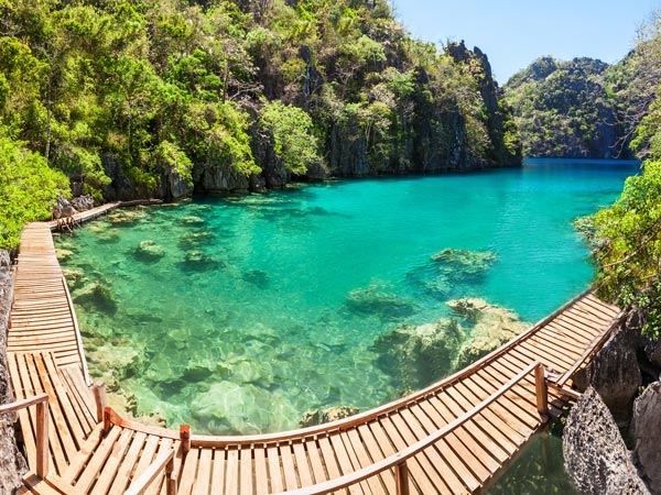 a walkway surrounding the emerald clear waters at Kayangan Lake in Coron, Palawan