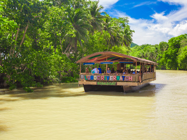 a traditional raft cruising along the Loboc River, Bohol, Philippines