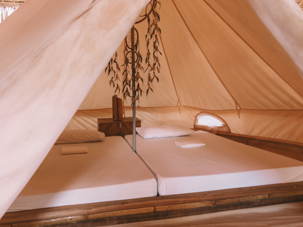 two beds inside a glamping tent in Mad Monkey Hostel Nacpan Beach, El Nido, Palawan
