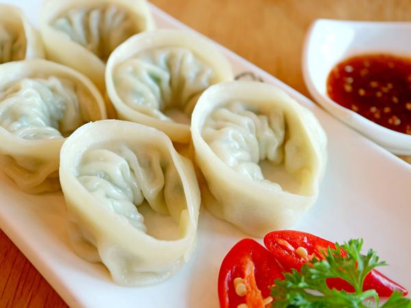 a plate filled with Korean dumplings or Mandu
