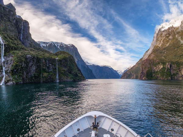 a tip of a boat sailing across Milford Sound