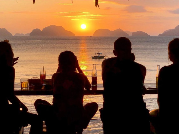 fellows drinking while watching the sunset at Republica Sunset Bar, El Nido, Palawan, Philippines