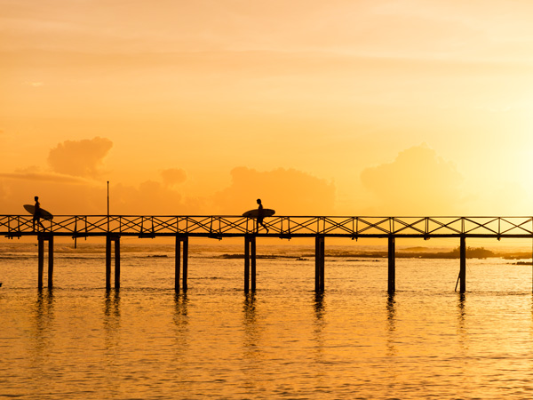 two surfers holding surfboards along Cloud 9, Siargao, Philippines