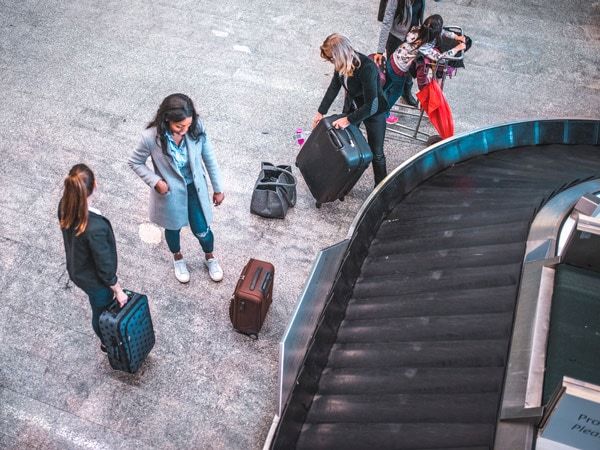 People with luggage at airport baggage carousel