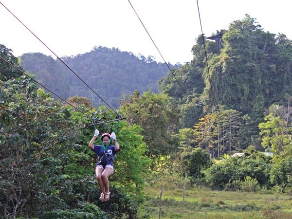 a woman riding a zipline at Ugong Rock, Puerto Princesa, Palawan, Philippines