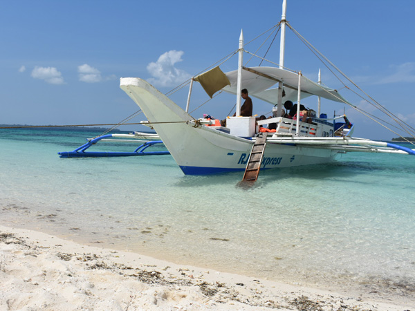 tourists aboard a traditional sailboat in Balabac, Palawan