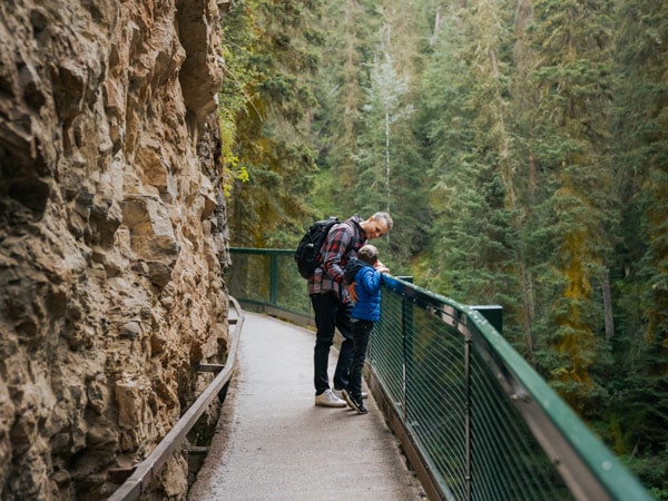 a father and son sightseeing along the Johnson Canyon Icewalk
