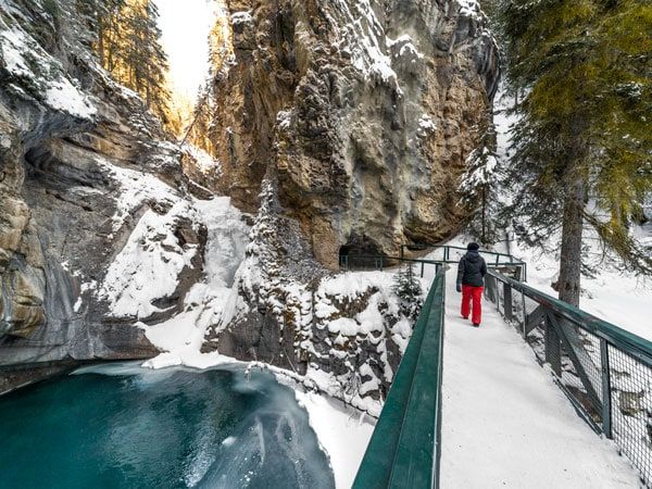 a male hiker walking along Johnston Canyon