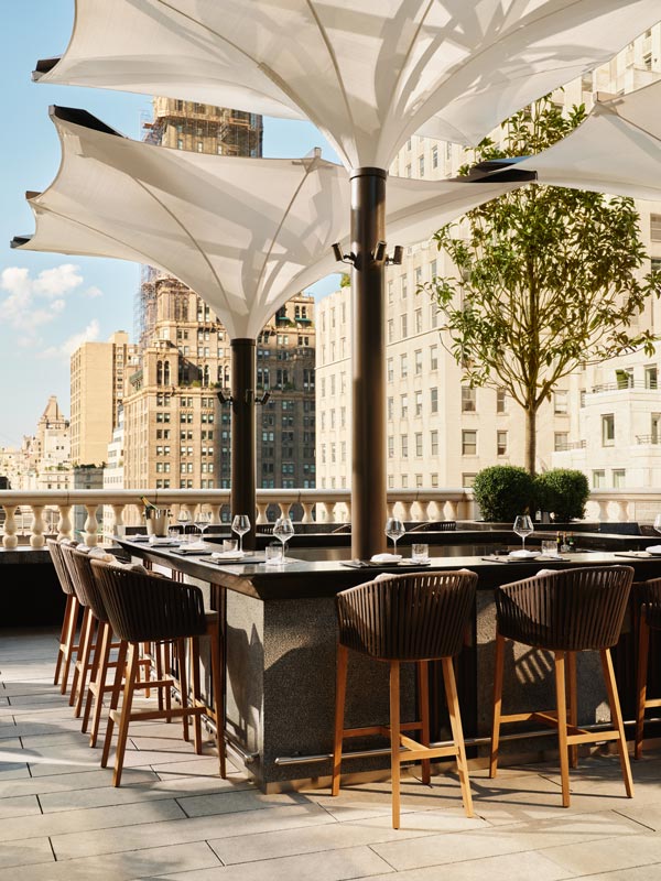 a garden and terrace bar at Aman New York