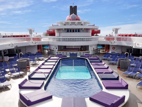 a pool with sun loungers at Aquatic Club Bar, Virgin Voyages’ Resilient Lady