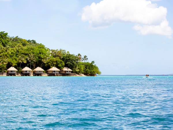 huts perched above the water on stilts at Iririki Island Resort