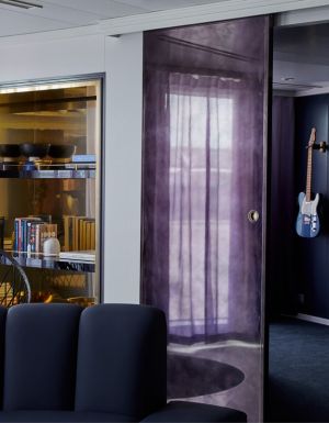 a media room stocked with four guitars at the massive suite, Virgin Voyages’ Resilient Lady
