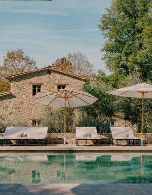 an outdoor pool with sun loungers at Vocabolo Mosacatelli