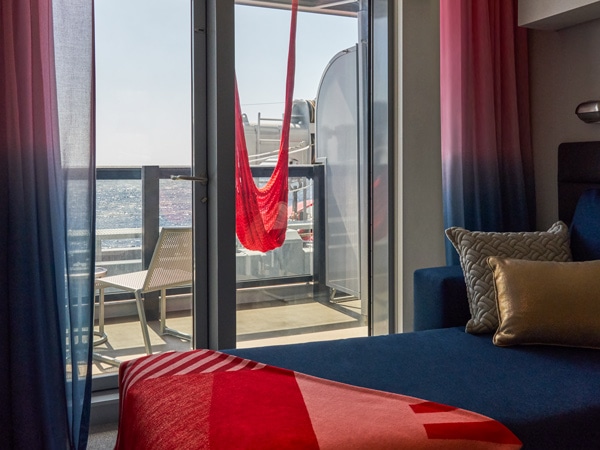 a balcony with a hammock in sea view cabin, Virgin Voyages’ Resilient Lady