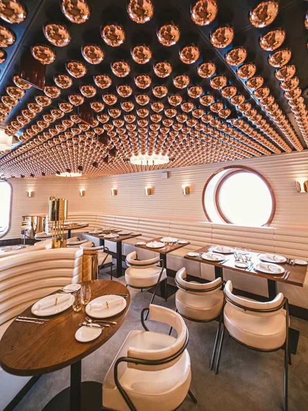 a spacious seating area at The Wake, Virgin Voyages’ Resilient Lady