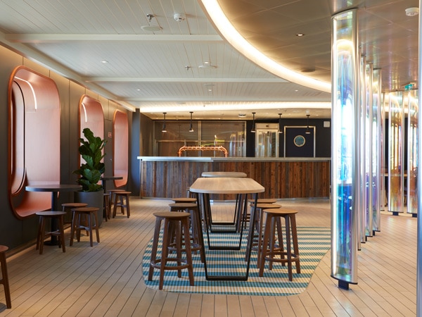 the bar interior at Draught Haus, Virgin Voyages’ Resilient Lady