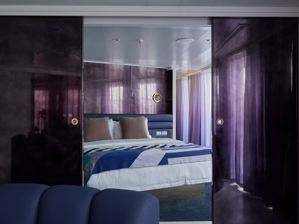 a king-sized bed in the massive suite, Virgin Voyages’ Resilient Lady