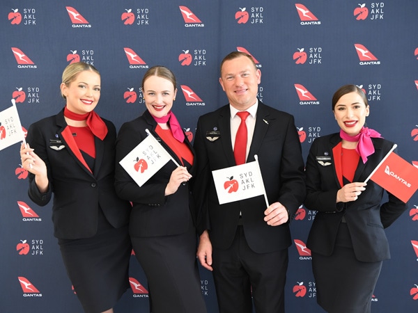 the flight crew of Qantas posing for a photo