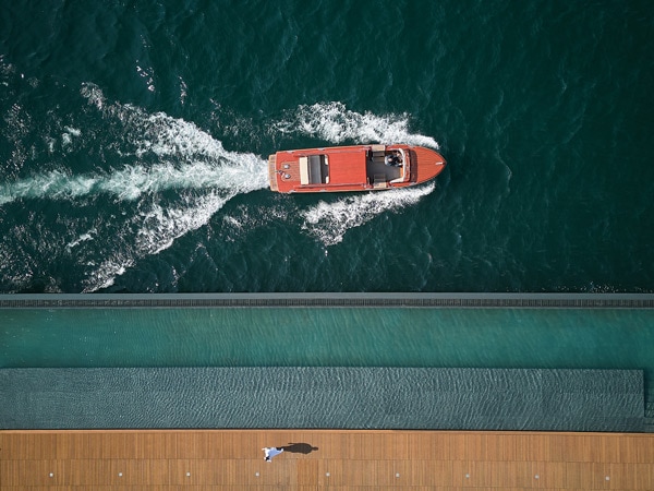an aerial shot of a yacht at Mandarin Oriental, Lago di Como
