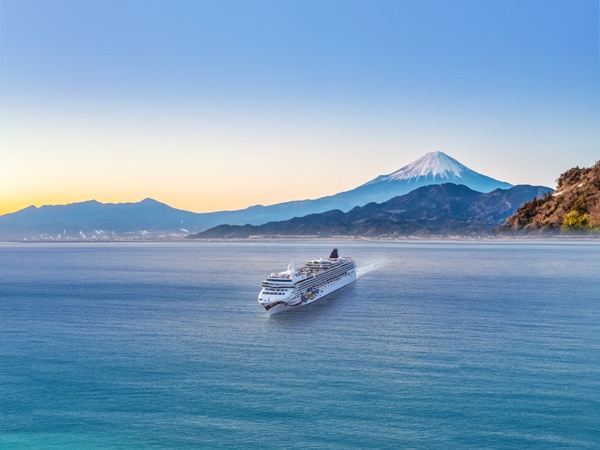 an aerial view of NCL Jewel sailing across Mount Fuji, Japan