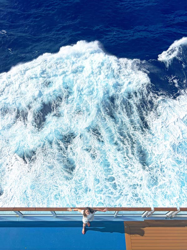 an overhead shot of the writer’s daughter, Emmie standing on the side of the Quantum of the Seas ship