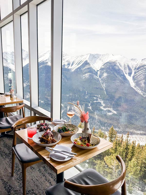 a dining setup with the Rocky Mountains as the backdrop at Sky Bistro