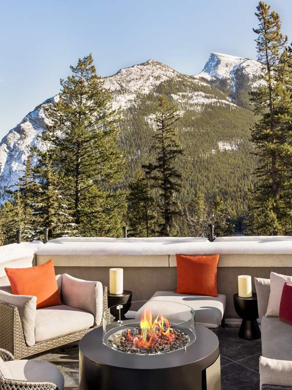Chairs and fireplace on Terrace Suite balcony of Fairmont Banff Springs